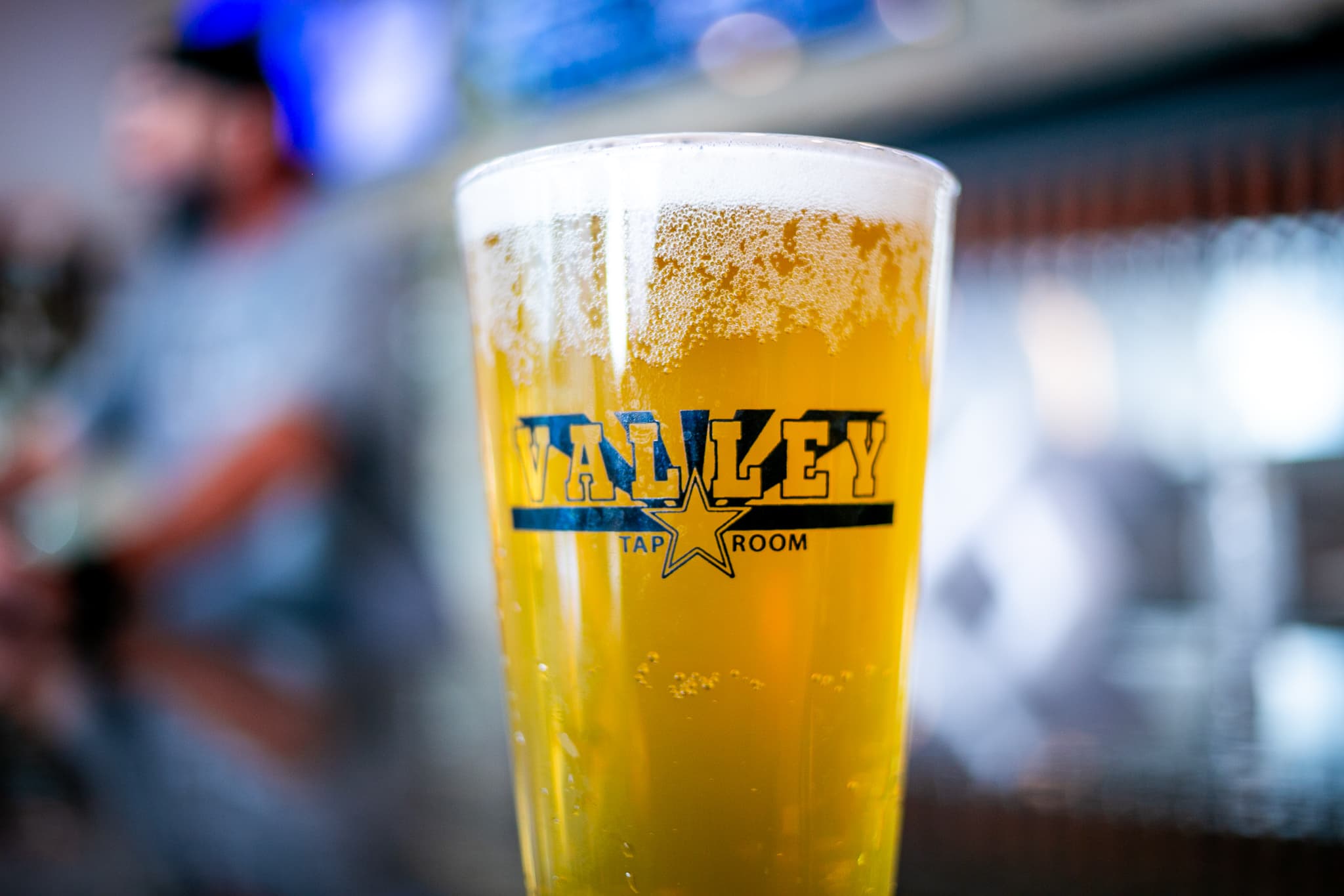 A cold pint poured in a branded Valley Taproom glass